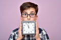 Surprised young boy with a clock Royalty Free Stock Photo