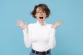 Surprised young brunette woman girl in casual white clothes, eyeglasses posing isolated on pastel blue background Royalty Free Stock Photo