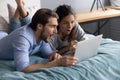 Surprised young family couple looking at computer screen. Royalty Free Stock Photo