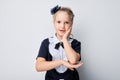 Surprised young girl with hands on cheeks against a gray background, expressing shock and amazement Royalty Free Stock Photo