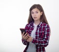 Surprised young girl holding phone on white background. Student with smartphone. Royalty Free Stock Photo