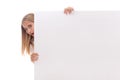 Surprised young girl is popping out from the side of white blank banner,isolated