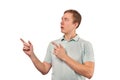 Surprised man with funny face in grey T-shirt pointing finger to left, white background Royalty Free Stock Photo