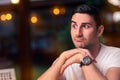 Surprised Young Man Sitting in a Restaurant Royalty Free Stock Photo