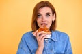 young woman eating pizza slice and looking delighted Royalty Free Stock Photo