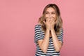 Surprised young woman excited cover open mouth with hands and look side happy laughing isolated Royalty Free Stock Photo