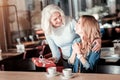 Surprised young woman getting a pretty present from her loving granny