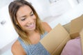 Surprised young woman opening carton box and smiling Royalty Free Stock Photo