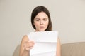 Surprised young woman reading unexpected letter Royalty Free Stock Photo