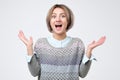 Surprised young woman shouting of happiness. studio shoot