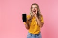 Surprised young woman showing display of mobile phone Royalty Free Stock Photo