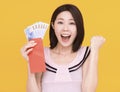 Surprised young woman showing the red envelope and money Royalty Free Stock Photo