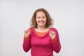 Surprised young woman smiling and holding her fists near face. She is shocked with sale prices. is it true. Royalty Free Stock Photo