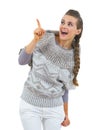 Surprised young woman in sweater pointing on copy space Royalty Free Stock Photo