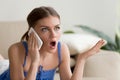 Surprised young woman talking on mobile phone Royalty Free Stock Photo