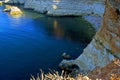 A cove among red rocks and a hard-to-reach beach.