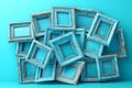 Surreal arrangement of antique blue picture frames on turquoise background Royalty Free Stock Photo