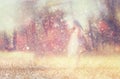 Surreal blurred background of young woman stands in forest. abstract and dreamy concept. image is textured and retro toned