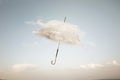 surreal cloud cover of an umbrella flying in the sky, abstract concept Royalty Free Stock Photo