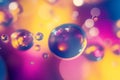 A surreal, colorful abstract background featuring floating liquid spheres. The glossy,