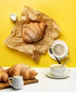 Surreal composition with coffee and croissants on a yellow background Royalty Free Stock Photo