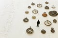 Surreal concept image of person looking at many vintage clocks
