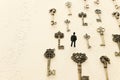 Surreal concept image of person looking at many vintage keys