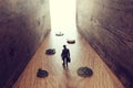 Surreal concept image of person passing by many vintage clocks