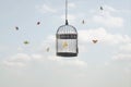 Surreal image of a butterfly trapped in a cage and other free flying butterflies