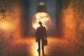 Surreal image of person in dark corridor looking at glowing light bulb. Concept of finding the right idea, or way out Royalty Free Stock Photo