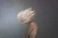 Surreal image of a white cloud covering a woman`s face, concept of freedom