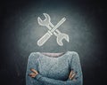 Surreal image young woman with crossed arms and wrench and screwdriver tools icon instead of head drawn over blackboard background