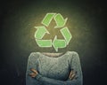 Surreal image young woman crossed hands and recycle symbol instead of head drawn over blackboard background. Ecology and greening