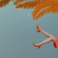 Surreal imaginary scene with a woman with her legs in the air, evening sky with quarter moon. Orange palm leaves in the background