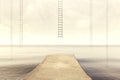 Surreal ladders rises up into the sky in a silent sea landscape Royalty Free Stock Photo
