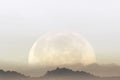Surreal landscape of a gigantic moon that illuminates the mountains