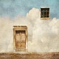 Surreal landscape with old door and window on cloudy sky