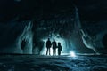 Surreal landscape with people exploring mysterious ice grotto cave. Outdoor adventure. Family exploring huge icy cave Royalty Free Stock Photo