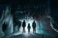 Surreal landscape with people exploring mysterious ice grotto cave. Outdoor adventure. Family exploring huge icy cave Royalty Free Stock Photo