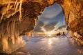 Surreal landscape with people exploring mysterious ice grotto cave. Outdoor adventure. Family exploring huge icy cave Royalty Free Stock Photo