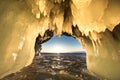 Surreal landscape with people exploring mysterious ice grotto cave. Outdoor adventure. Family exploring huge icy cave Royalty Free Stock Photo