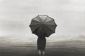 Surreal lonely woman walks in the sea in the rain protected by an umbrella