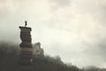 Surreal man with telescope looks at infinity from the top of a stack of books in the outdoors