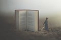 Surreal moment of a woman with lantern walking confused in the fog between giant books Royalty Free Stock Photo