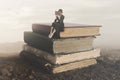 Surreal image of a woman reading sitting on top of a book Royalty Free Stock Photo