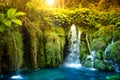 Surreal natural lake waterfall with blue, turquoise water and tropical forest Royalty Free Stock Photo
