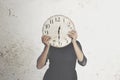 Surreal photo of a woman hiding behind a big clock