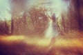 Surreal photo of young woman standing in forest. i