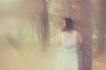 Surreal photo of young woman standing in forest. image is textured and toned. dreamy concept Royalty Free Stock Photo