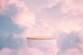 Surreal podium outdoor on blue sky pink gold pastel soft clouds with space.Beauty cosmetic product placement pedestal present